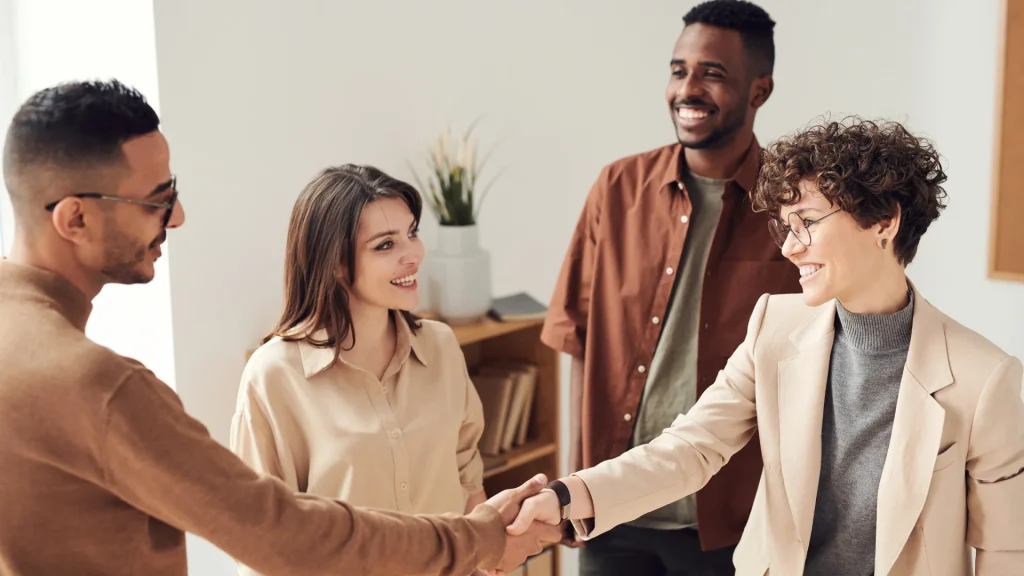 A group of people shake hands.