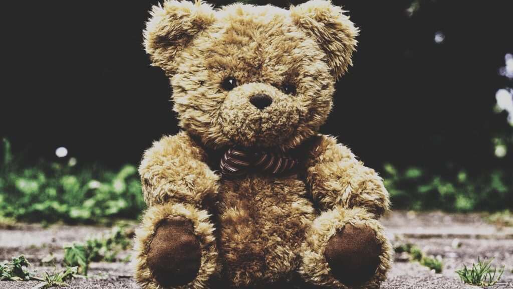 Teddy bear sitting alone against a wall, symbolizing the isolation and pain experienced by survivors of childhood sexual abuse and incest
