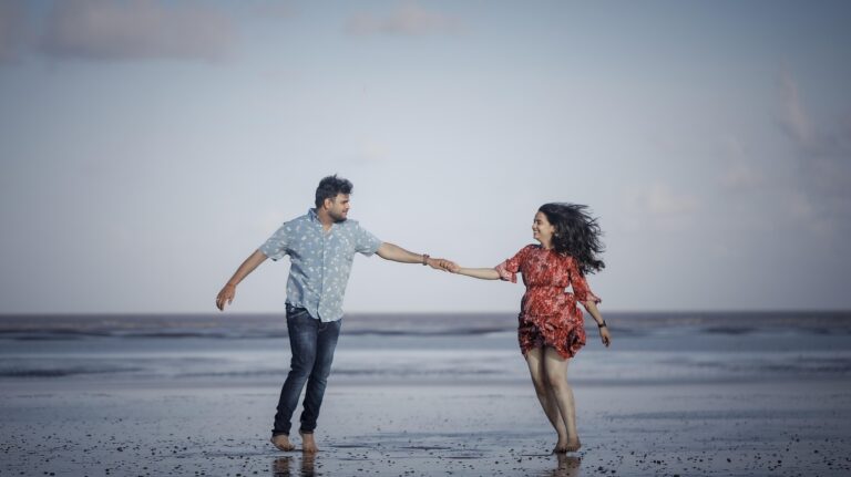 A couple holding hands in a heart-shaped frame, symbolizing secure attachment, love, and interdependent relationships in counselling.