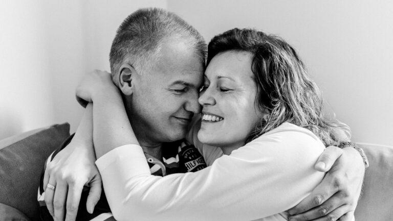 Couple embracing outdoors, symbolizing emotional attunement and connection in relationships—representing how presence matters more than love languages in couples therapy.