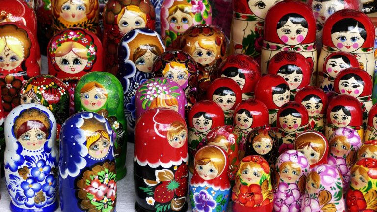 A set of Russian nesting dolls opened to reveal multiple layers, symbolizing psychedelic integration therapy and the unfolding meaning of a psychedelic or visionary experience over time.